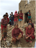 Picture of villagers in front of damage from earthquake.