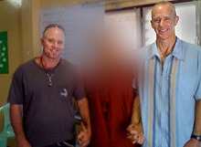 Mark Kirwin holding hands with two other males in solidarity